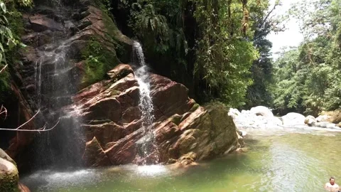 Drone Flying Over Emerald River and Small Waterfall Stock Footage 343421199