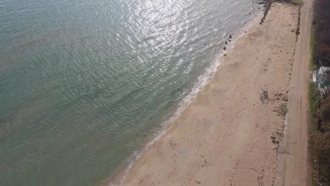 Drone flying over empty beach and waves on sunny coast Stock Footage 321047191