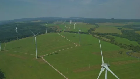 Drone Flying Over Field with Multiple Wind Turbines Stock Footage 314940393