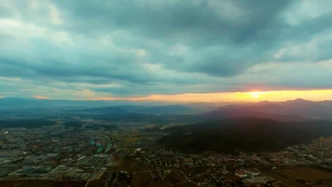 Drone flying over a field surrounded by trees showing the stormy clouds Video stock 89619118