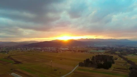 Drone flying over a field surrounded by trees showing the stormy clouds Video stock 89619750