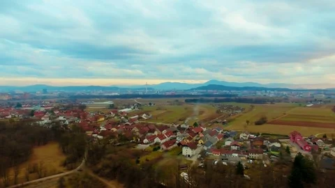 Drone flying over a field surrounded by trees showing the stormy clouds Video stock 89620350
