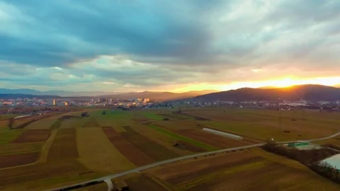 Drone flying over a field surrounded by trees showing the stormy clouds Video stock 89620459