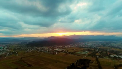 Drone flying over a field surrounded by trees showing the stormy clouds Video stock 89620679