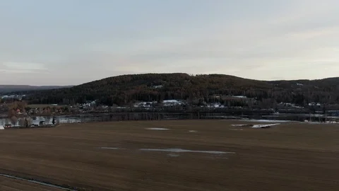 Drone flying over field towards a mountain Stock Footage 124030646