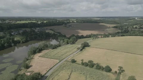 Drone Flying Over Fields, Forest &amp; Pond with Moving Cloud Shadows, France Stock Footage 302566017