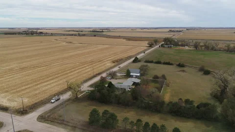Drone Flying Over Fields Of Rolled Hay Bales And Four Way Intersection Stock Footage 229185504