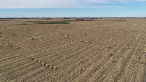 Drone Flying Over Fields Of Rolled Hay Bales And Four Way Intersection Stock Footage 229186493