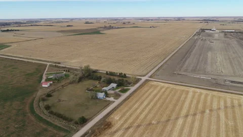 Drone Flying Over Fields Of Rolled Hay Bales Toward House Stock Footage 229187309