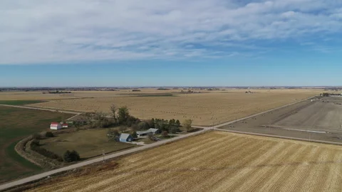 Drone Flying Over Fields Of Rolled Hay Bales And House Stock Footage 229188408
