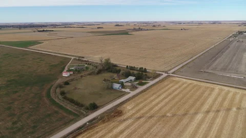 Drone Flying Over Fields Of Rolled Hay Bales And House Stock Footage 229188578