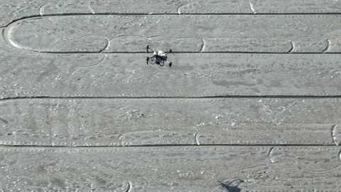 A drone flying over flooded rice fields, evenly dropping seeds. Stock Footage 309848800