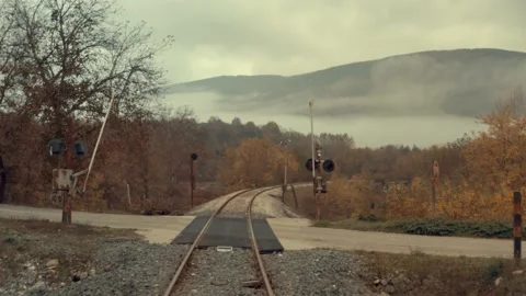 Drone flying over following empty road and railroad tracks in Autumn Stock Footage 146986032