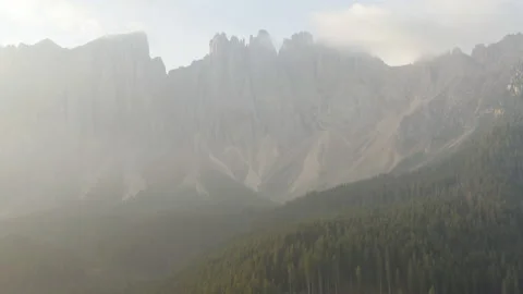 Drone flying over forest during sunrise in the Dolomites Stock Footage 143374102