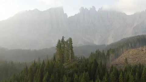 Drone flying over forest during sunrise in the Dolomites Stock Footage