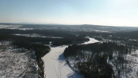 Drone flying over the frozen river Lozva, the road to the Dyatlov Pass Stock Footage 170106477