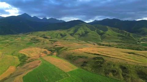 Drone flying over green fields and mountains in Kyrgyzstan Stock Footage 344997149