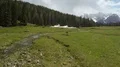 Drone flying over green valley with rivulet, view on Dolomites, cool landscape 4k or 4k+ Resolution