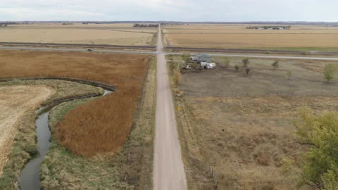 Drone Flying Over Harvested Fields Following Dirt Road Away From Intersection Stock Footage 229185269