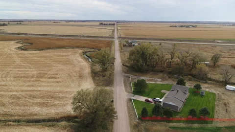 Drone Flying Over Harvested Fields Following Dirt Road Away From Intersection Stock Footage 229185619
