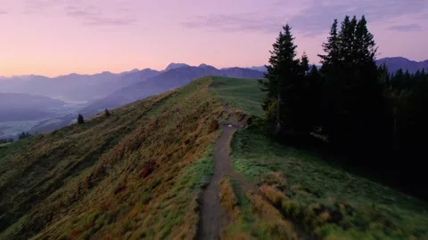 Drone flying over Hiking Path towards Mountain Top at Sunrise in the Alps Stock Footage 236492819