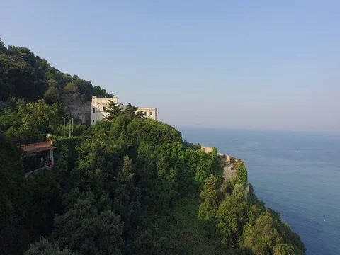 Drone Flying over the hills around the small seaside town Stock Footage 72620116