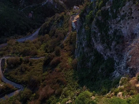 Drone Flying over the hills overlooking the sea in a small Sicilian village Stock Footage 72577543