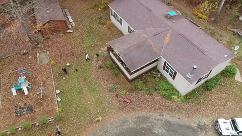 Drone Flying Over House In Middle Of Autumn Forest With Children Playing Stock Footage 229157880
