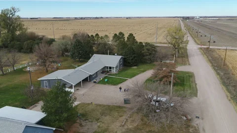 Drone Flying Over House Surrounded By Harvested Fields Stock Footage 229187202