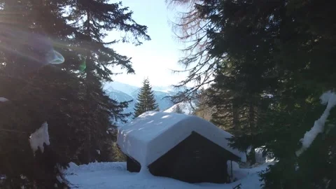 Drone flying over idyllic snow covered mountain cabin Stock Footage 145800405