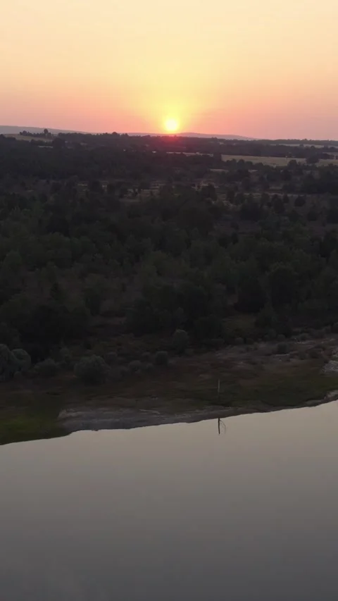 Drone flying over La Cuerda del Pozo Reservoir at sunset in Soria, Spain Видео 342607650