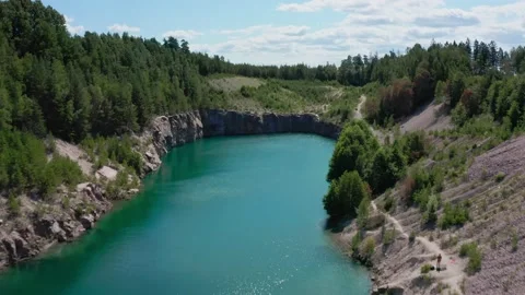 Drone flying Over Lagoon In A Former Limestone Quarry Stock Footage 168817728