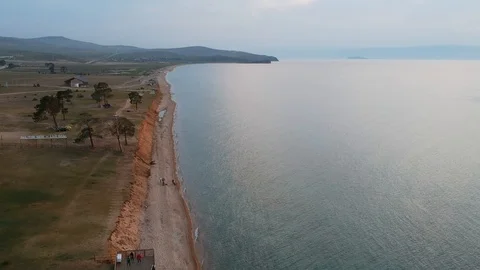 The drone is flying over the lake along the shore. View of the Baikal, Olkhon Stock-Footage 123915053