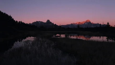 Drone flying over lake in austria during sunset with mountain range Stock Footage 102658542