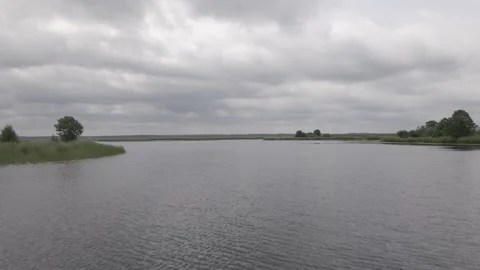 Drone flying over a lake in a cloudy overcast day Stock Footage 161153603