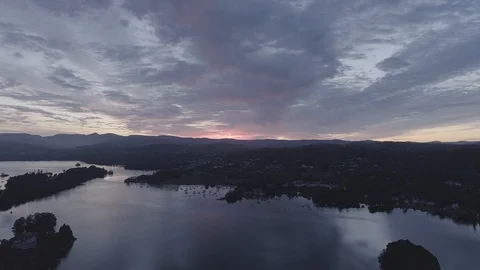Drone Flying over a lake facing sunrise - DLog, Windermere, Lake District Stock Footage 90913721