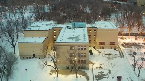 Drone flying over lake in park la fontaine exposing the primary school inside 库存影片 329002730