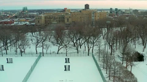 Drone flying over lake in park lafointaine montreal winter overlooking courts Stock Footage 329002885