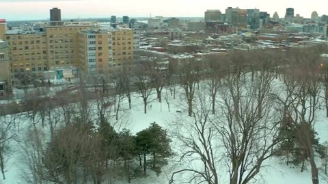 Drone flying over lake in park lafointaine montreal winter fron notre dame Stock Footage 329003629
