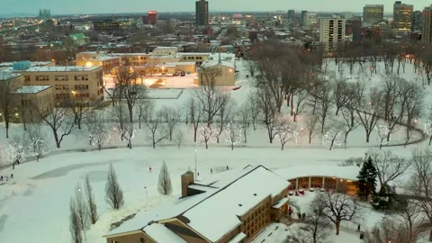 Drone flying over lake in park lafointaine montreal some people ski also main Stock Footage 329003739