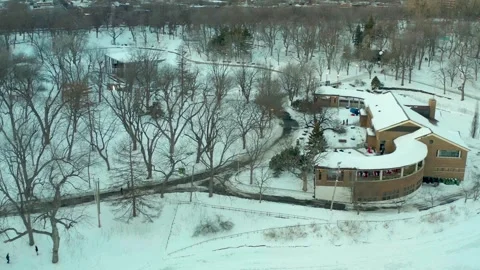 Drone flying over lake in park lafointaine montreal some people ski Stock Footage 329003837