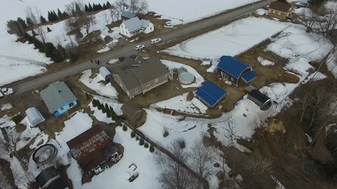 Drone flying over landslide in winter with rural houses - 24fps 1080p Stock Footage 104068899