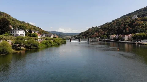 Drone flying over large river near mountain city Stock Footage 122177195