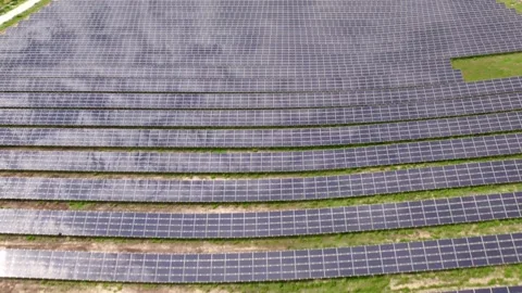 Drone flying over a large solar panel farm for green energy production Video stock 343831681