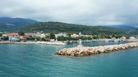 Drone flying over a lighthouse in a small city near the sea Stock Footage 117429571