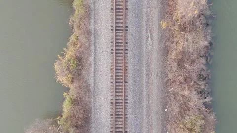 Drone Flying over Marsh, Island &amp; Railroad near River Stock Footage 311609231