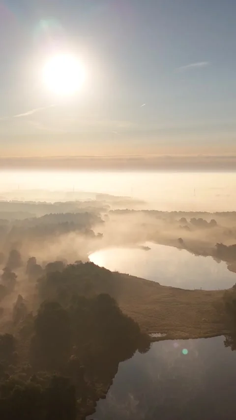 Drone flying over misty lake at sunrise Stock Footage 327111753