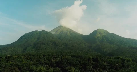 Drone flying over mountain forest with golden sunlight and atmospheric haze Stock Footage 333308117