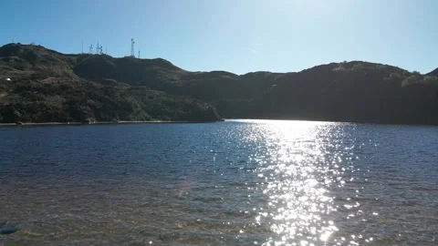 Drone Flying Over Mountain Lake With Sunlight Reflections Stock Footage 343419110