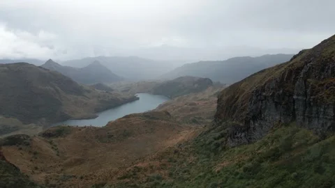 Drone Flying Over Mountain Lake Under Cloudy Sky Stock Footage 343419451